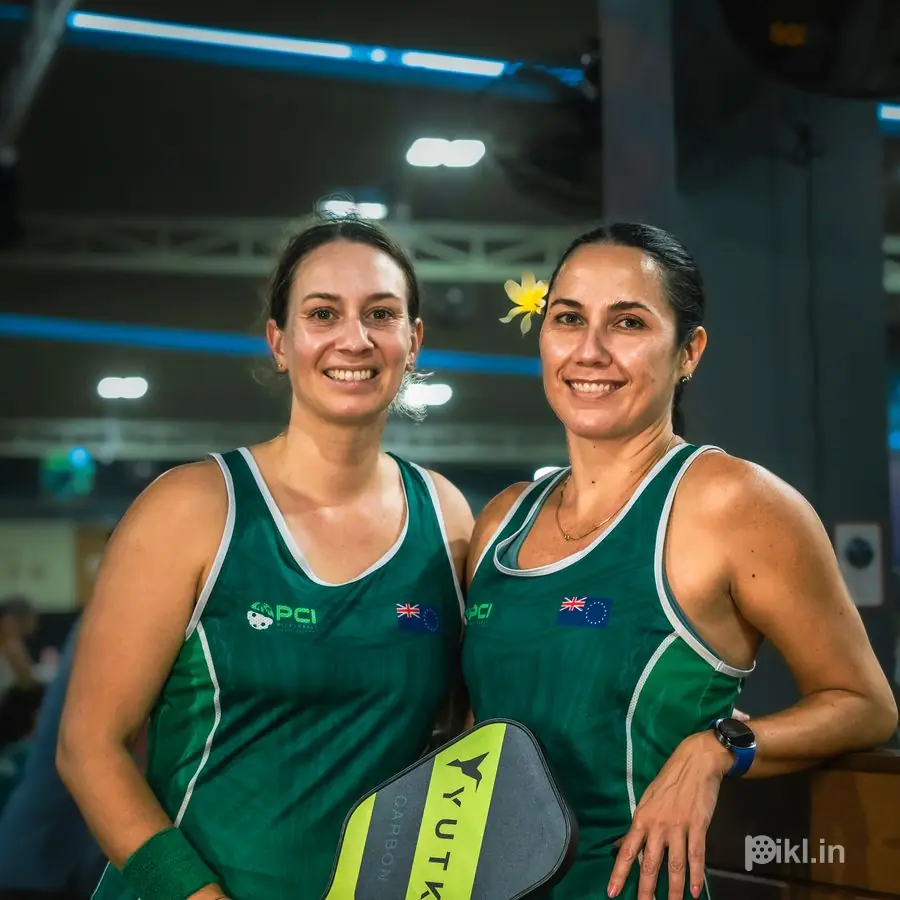 Doubles partners sharing a paddle, matching kit