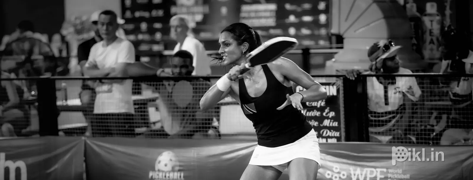 Black and white crouch at the baseline, World Cup boards behind
