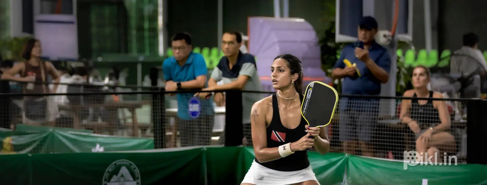 Ready position at the baseline, full court in frame